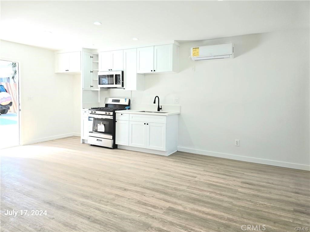 8734 Ramsgate Avenue Los Angeles, CA 90045 - Photo 2 of 9 a view of kitchen with wooden floor