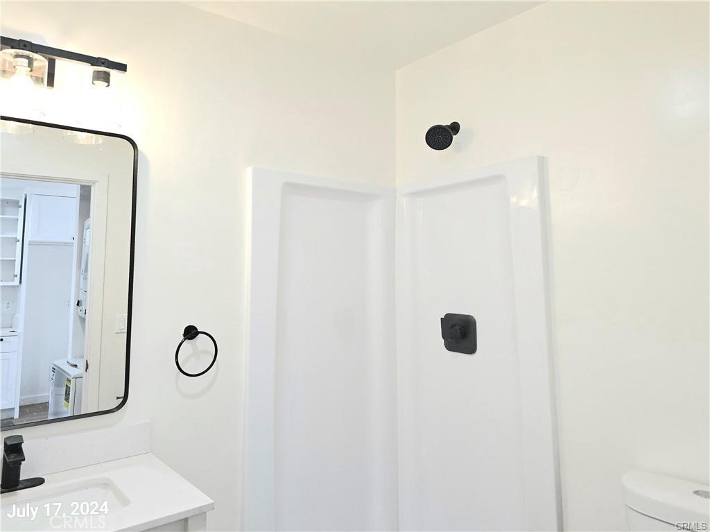 8734 Ramsgate Avenue Los Angeles, CA 90045 - Photo 7 of 9 a bathroom with a granite countertop shower and a mirror