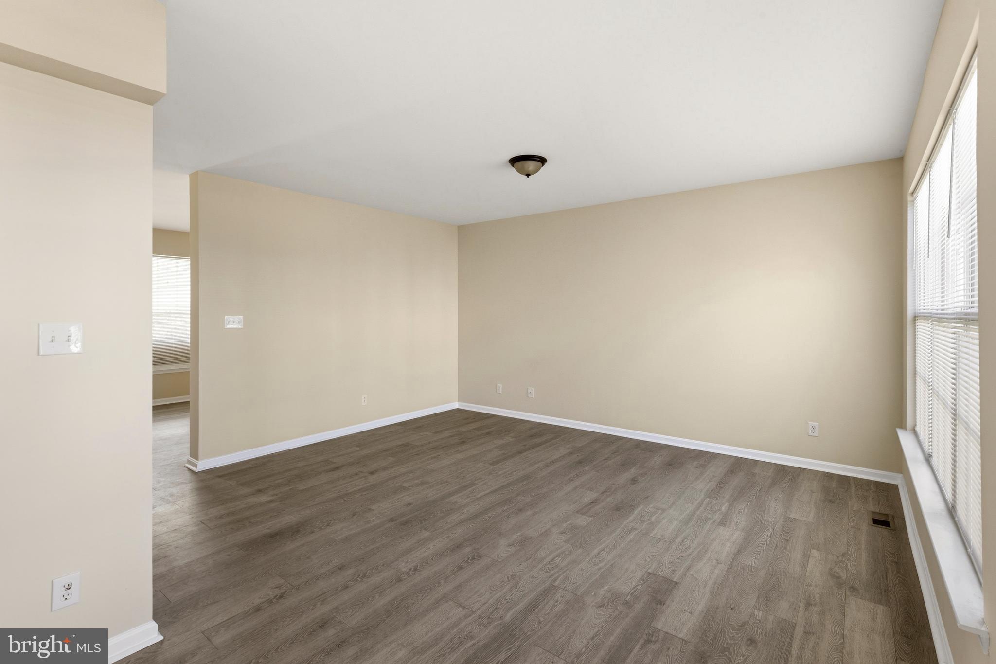 4704 Denview Way Baltimore, MD 21206 - Photo 10 of 42 an empty room with wooden floor and windows