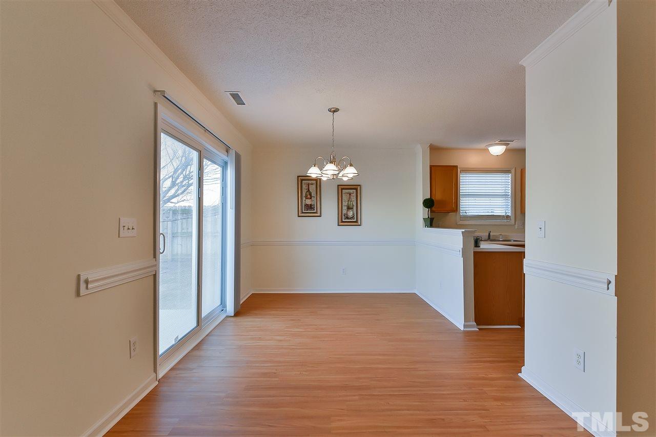 4309 Standing Rock Way Raleigh, NC 27604 - Photo 4 of 7 an empty room with wooden floor and windows