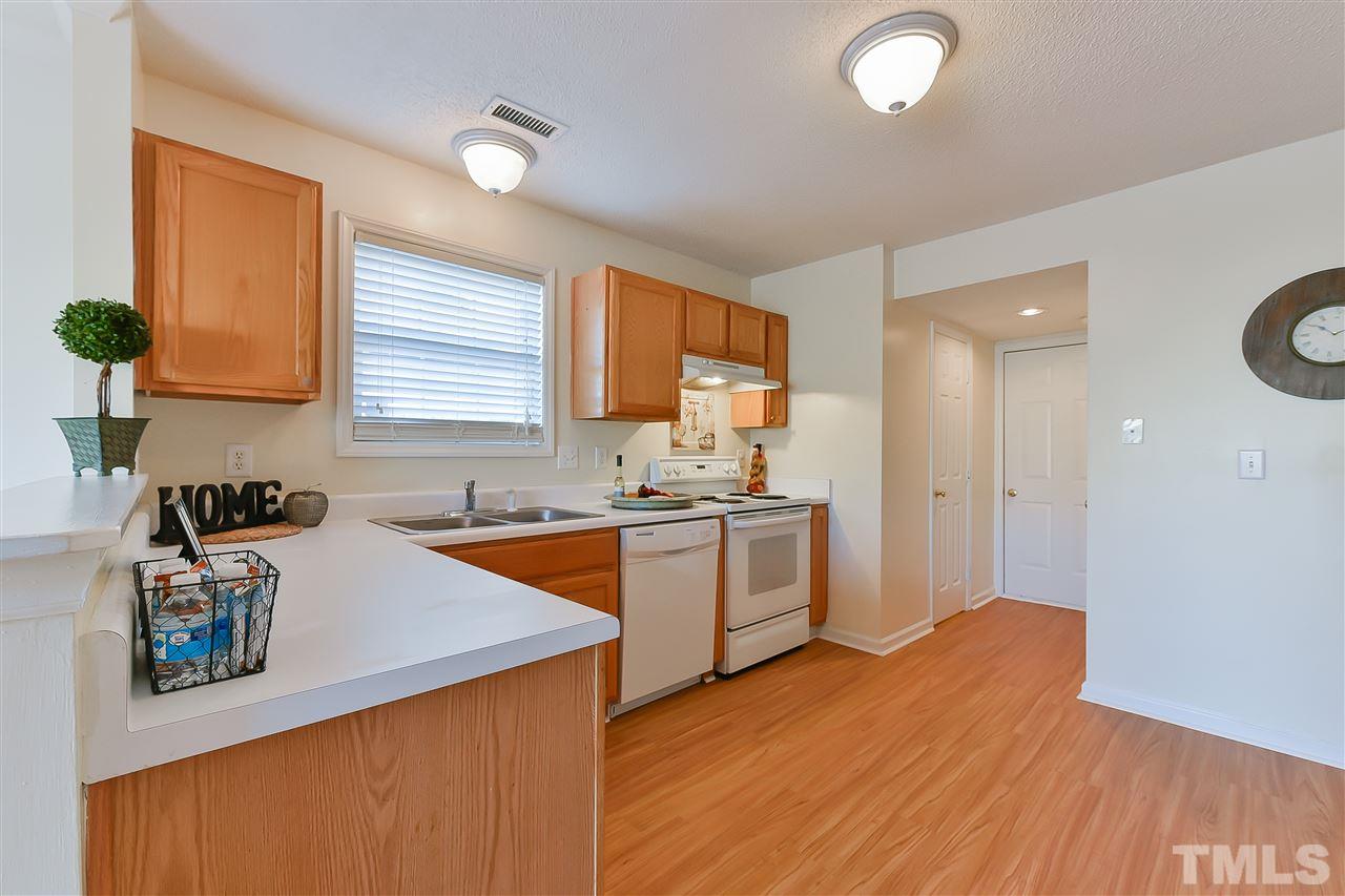 4309 Standing Rock Way Raleigh, NC 27604 - Photo 5 of 7 a kitchen with a sink a stove and cabinets