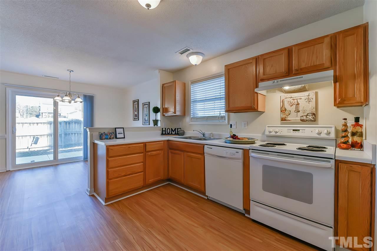 4309 Standing Rock Way Raleigh, NC 27604 - Photo 6 of 7 a kitchen with stainless steel appliances granite countertop wooden floors and sink