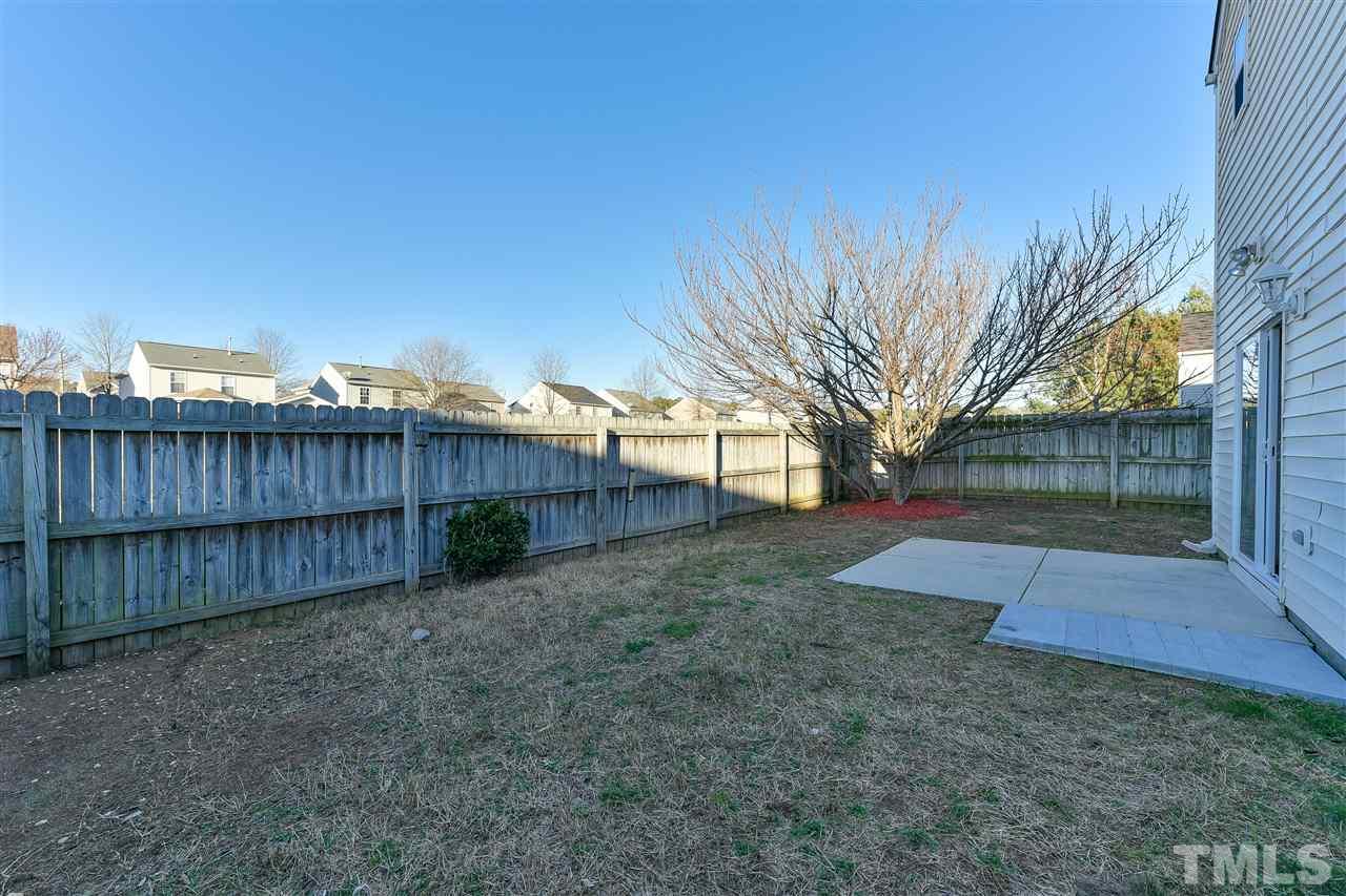 4309 Standing Rock Way Raleigh, NC 27604 - Photo 7 of 7 a view of a backyard with wooden fence