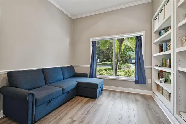 a living room with furniture and a book shelf