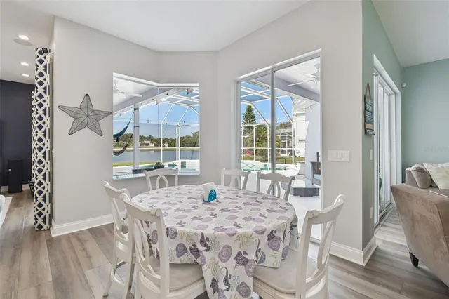 a dining room with furniture a chandelier and wooden floor