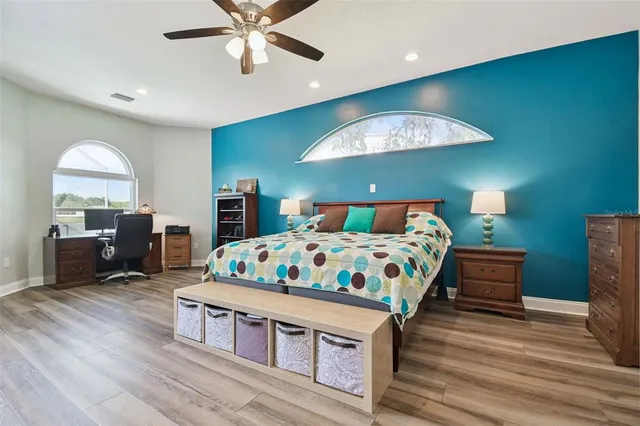 a bedroom with a bed and a chandelier