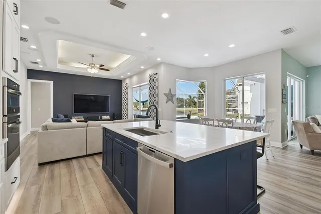 a kitchen with sink stove and refrigerator