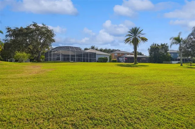 a view of a house with a yard and sitting area