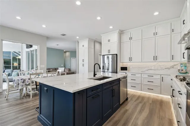 a kitchen with counter top space sink stove and cabinets