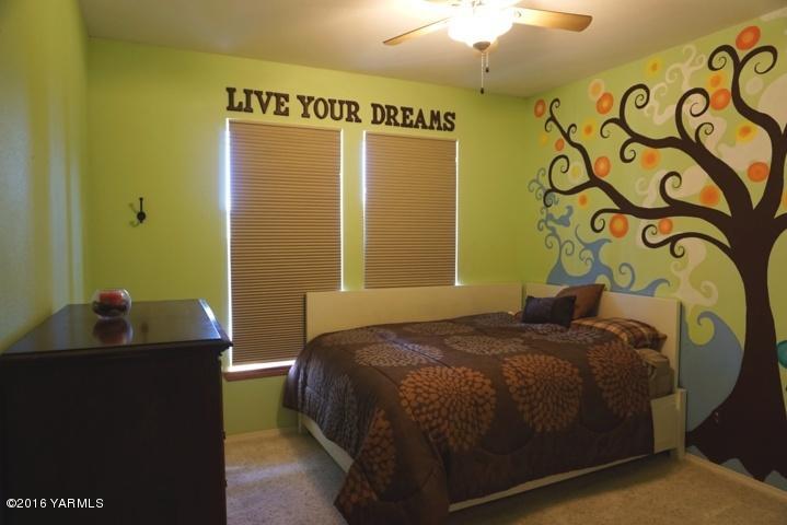767 East Charron Road Moxee, WA 98936 - Photo 11 of 24 a bedroom with a bed and a mirror