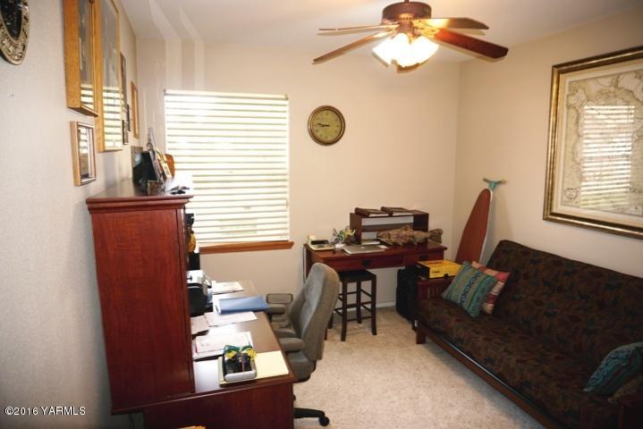 767 East Charron Road Moxee, WA 98936 - Photo 12 of 24 a view of a livingroom with workspace and a window