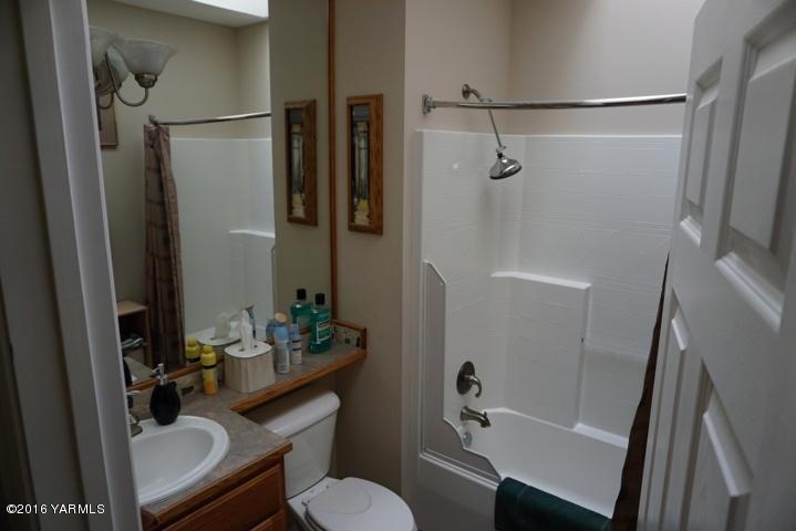 767 East Charron Road Moxee, WA 98936 - Photo 13 of 24 a bathroom with a sink toilet and shower
