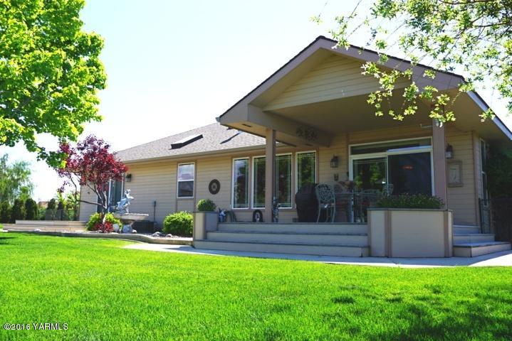 767 East Charron Road Moxee, WA 98936 - Photo 14 of 24 a view of a house with a yard porch and sitting area