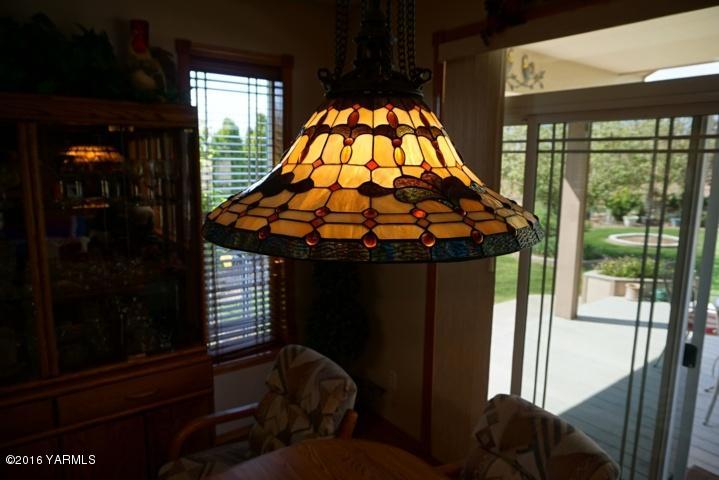 767 East Charron Road Moxee, WA 98936 - Photo 7 of 24 a bed sitting in a bedroom next to a window