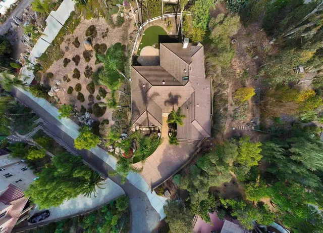 an aerial view of a house with a yard