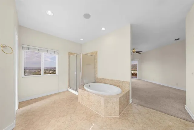 a bathroom with a tub and a shower