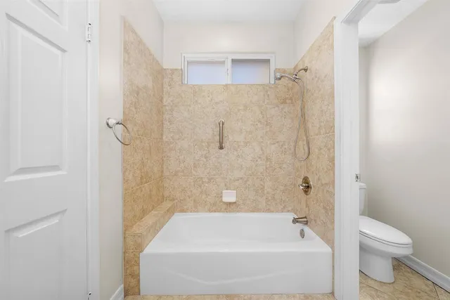a bathroom with a bathtub and a toilet