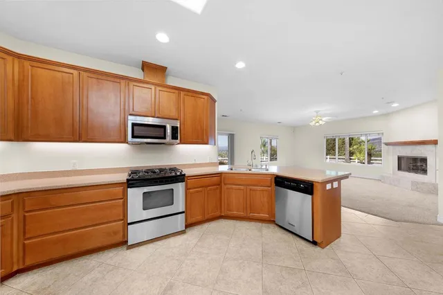 a kitchen with granite countertop stainless steel appliances and sink