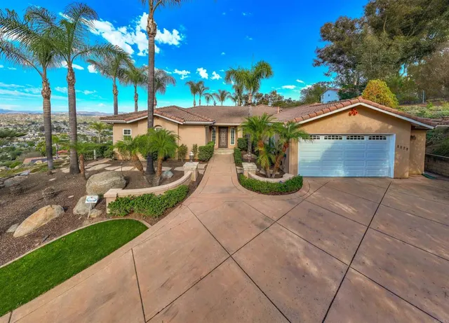 a view of a house with a yard and a garden
