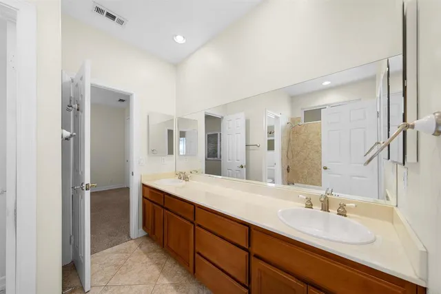 a spacious bathroom with a double vanity sink mirror and double