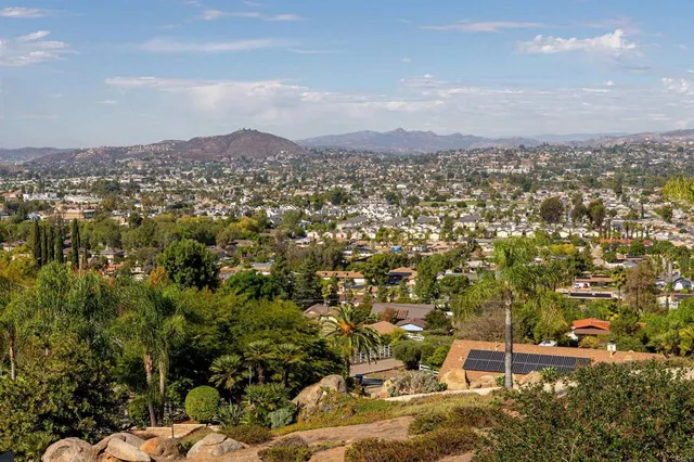 an aerial view of residential house with parking space and mountain view in back