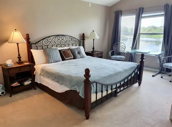 a bedroom with two beds and a window