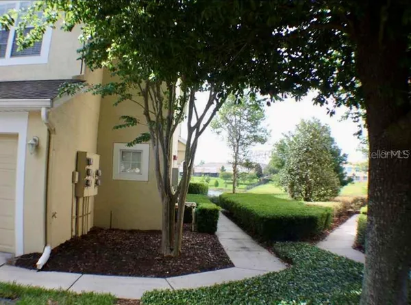 a view of a house with potted plants