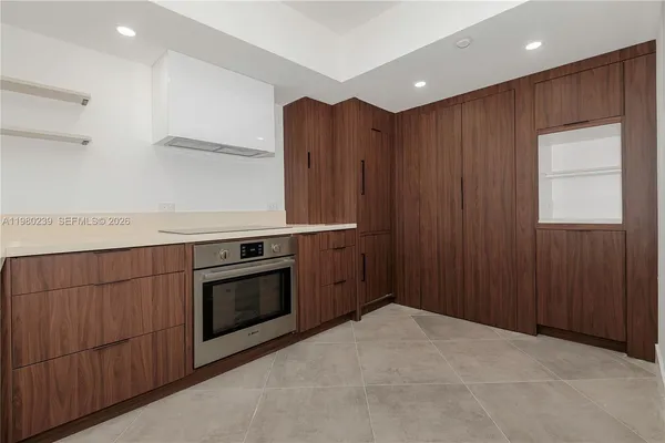 a kitchen with granite countertop wooden cabinets and stainless steel appliances