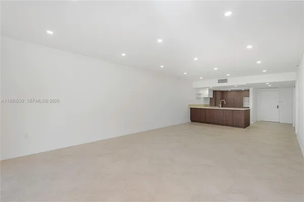 a big room with wooden floor and windows