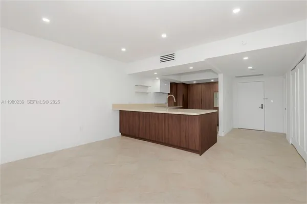 a kitchen with a refrigerator and a counter top