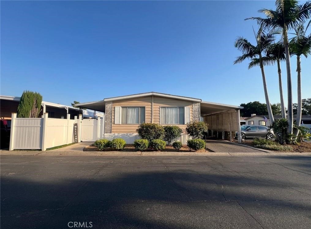 a front view of a house with a garden and yard