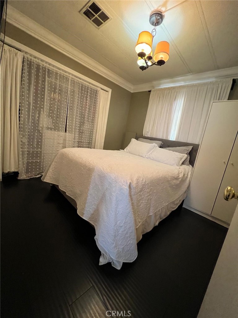 201 West Collins Avenue, Unit 40 Orange, CA 92867 - Photo 14 of 15 a bedroom with a bed and a window