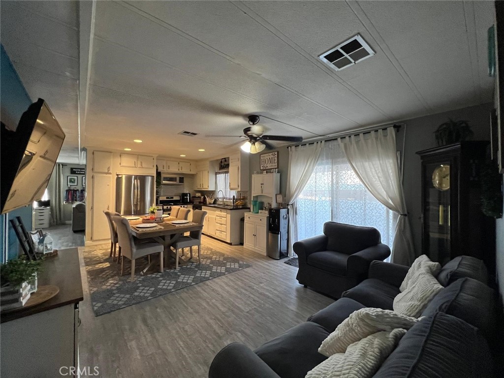 201 West Collins Avenue, Unit 40 Orange, CA 92867 - Photo 15 of 15 a living room with furniture and a flat screen tv