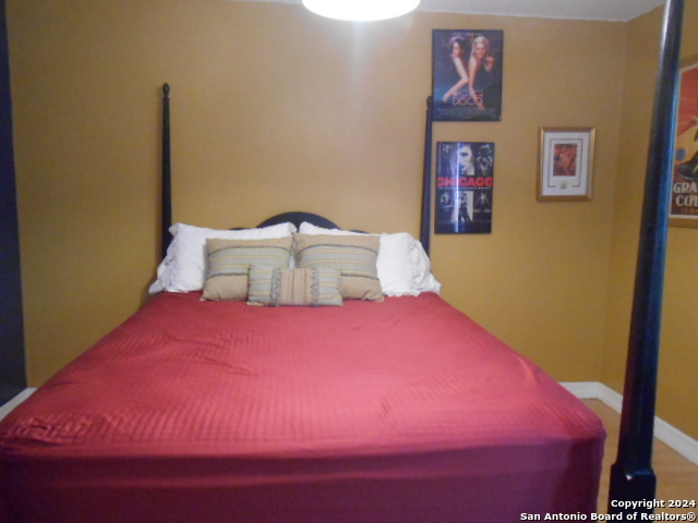 2300 Nacogdoches Road, Unit 118E San Antonio, TX 78209 - Photo 25 of 35 a bedroom with a bed and painting on the wall