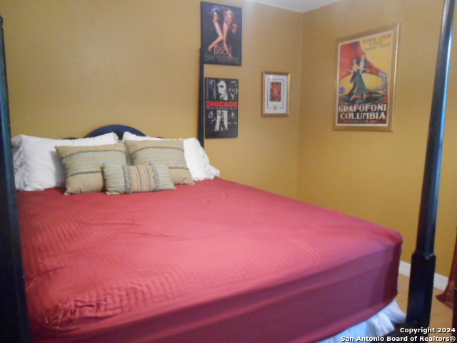 2300 Nacogdoches Road, Unit 118E San Antonio, TX 78209 - Photo 26 of 35 a bedroom with a bed and painting on the wall