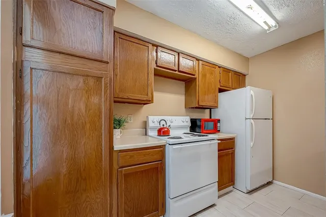 a kitchen with a refrigerator a sink and cabinets
