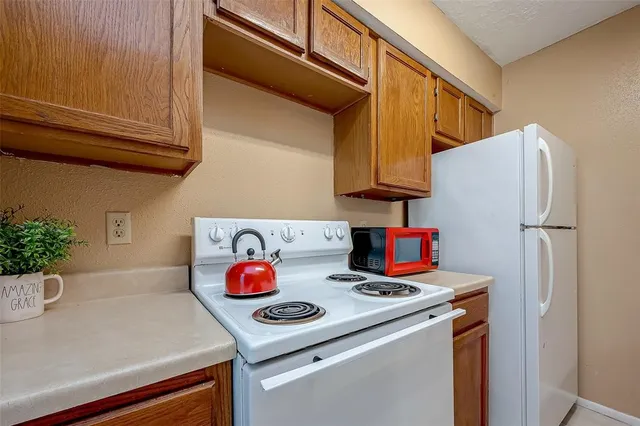 a kitchen with a refrigerator and a sink