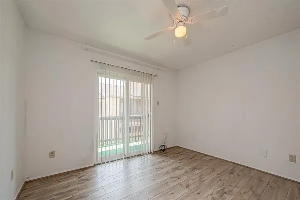 a view of small space with wooden floor and a window