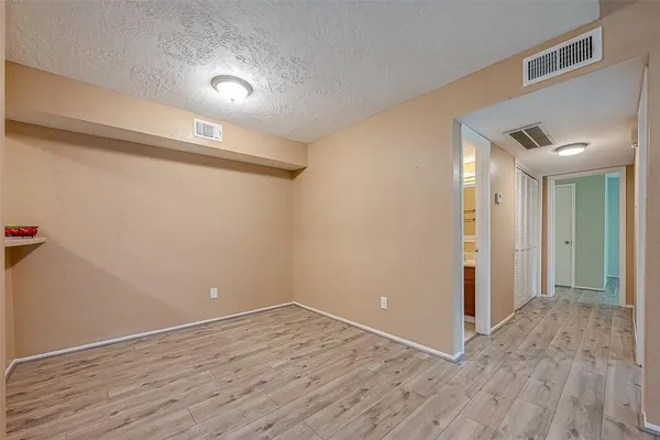 a view of a room with wooden floor