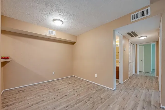 a view of a room with wooden floor