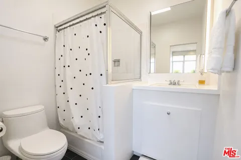 a white toilet sitting next to a bathroom sink
