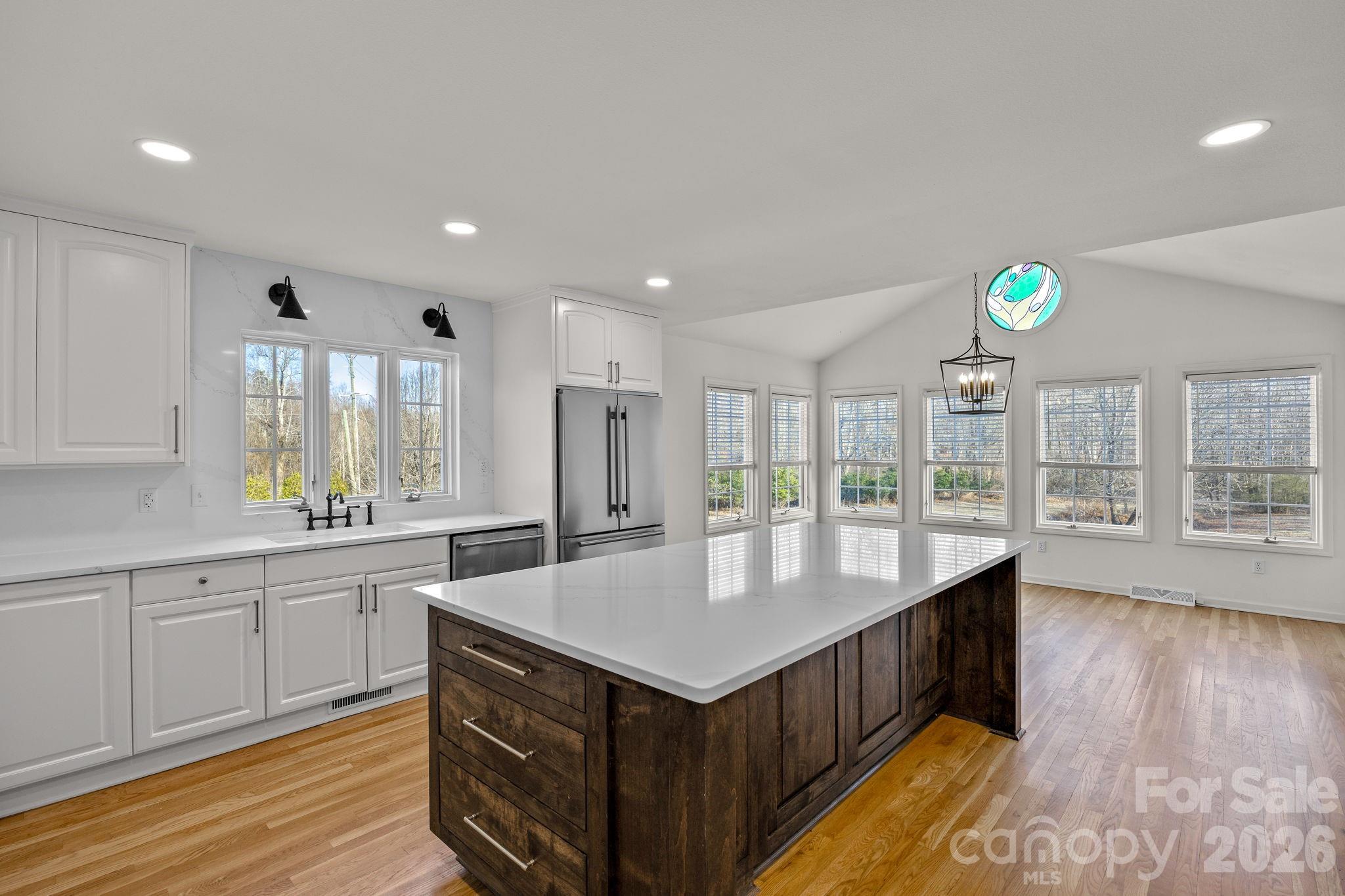 1 Sweetbriar Court Greer, SC 29650 - Photo 11 of 48 a kitchen with kitchen island granite countertop a sink a counter top space and stainless steel appliances