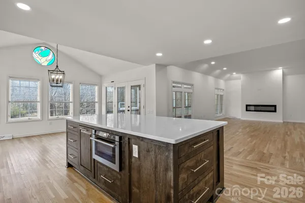 a kitchen with kitchen island a sink stainless steel appliances and a counter top space