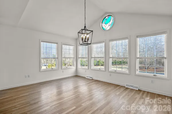 a view of livingroom with window wooden floor and chandelier
