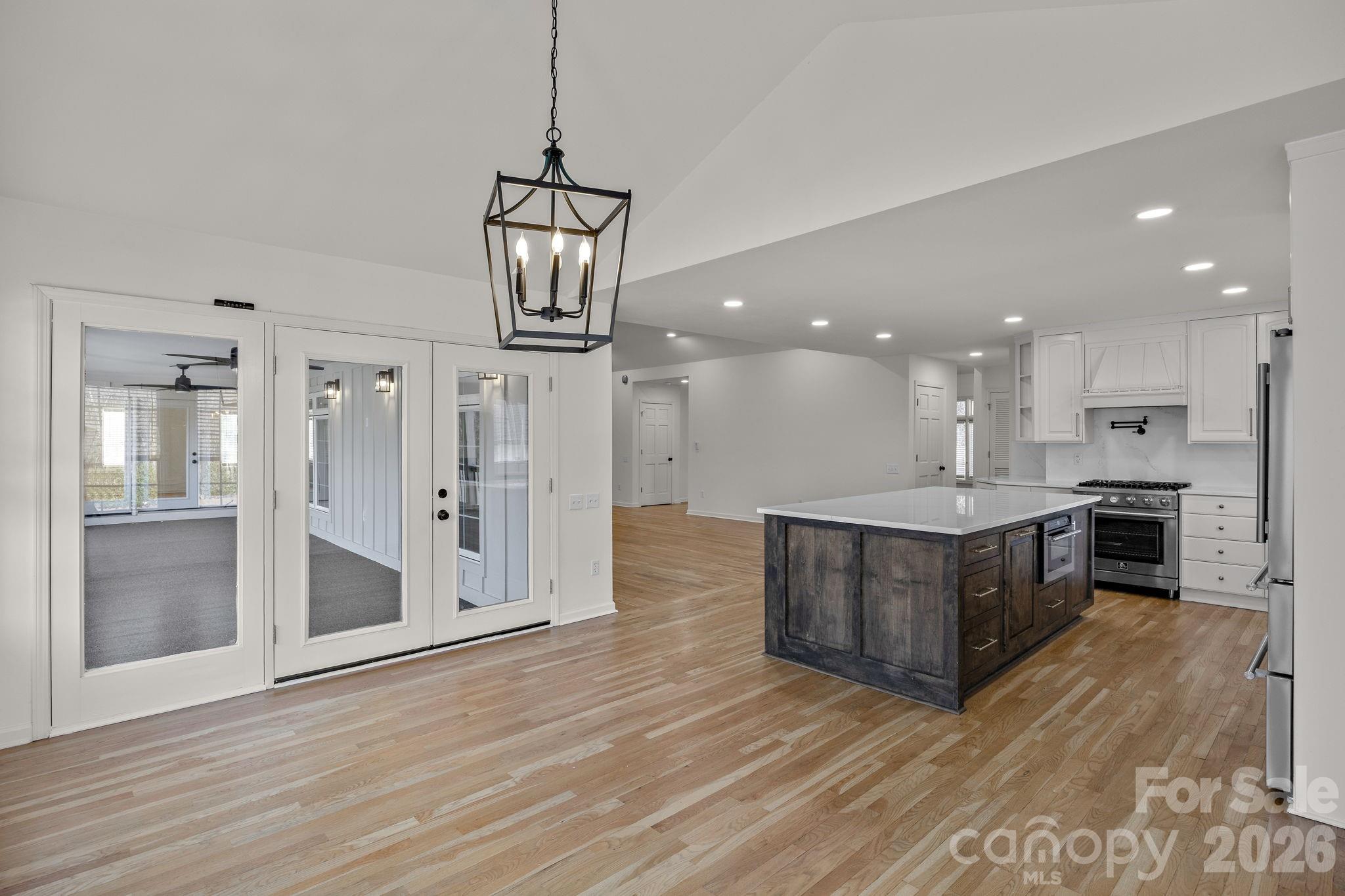 1 Sweetbriar Court Greer, SC 29650 - Photo 15 of 48 a view of kitchen with granite countertop stainless steel appliances cabinets a wooden floor and a chandelier