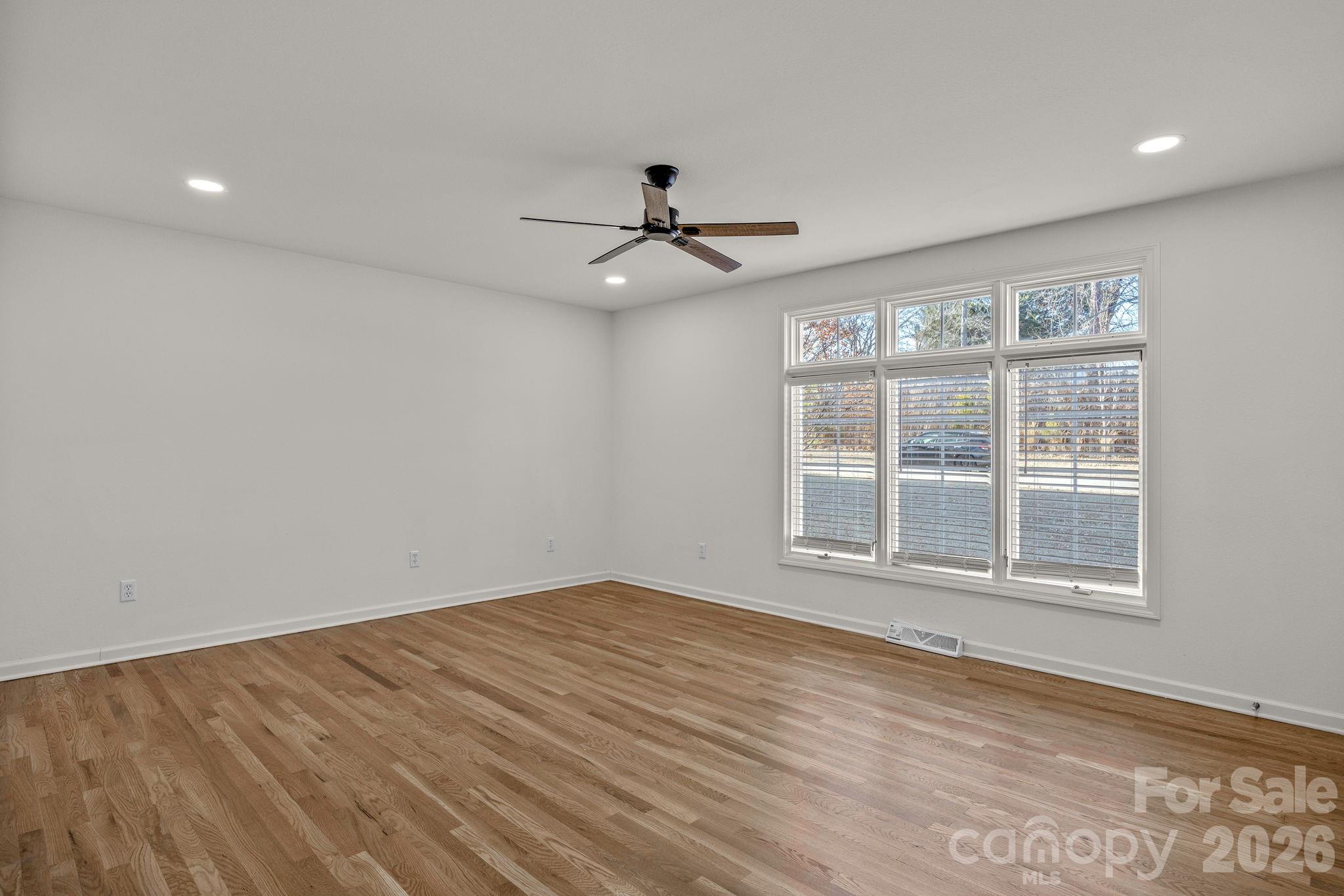 1 Sweetbriar Court Greer, SC 29650 - Photo 22 of 48 en empty room with a window and ceiling fan