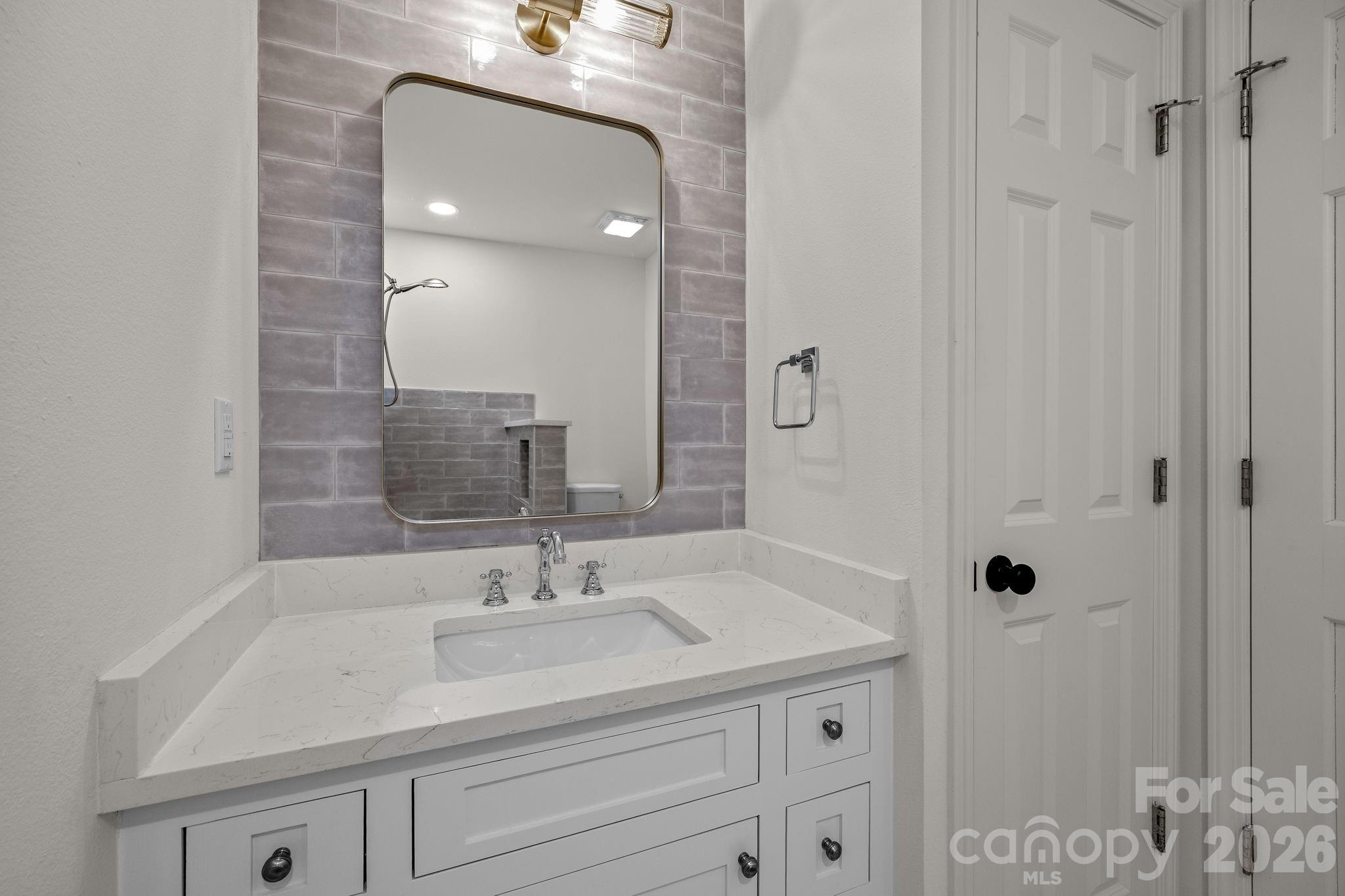 1 Sweetbriar Court Greer, SC 29650 - Photo 27 of 48 a bathroom with a sink vanity granite and shower