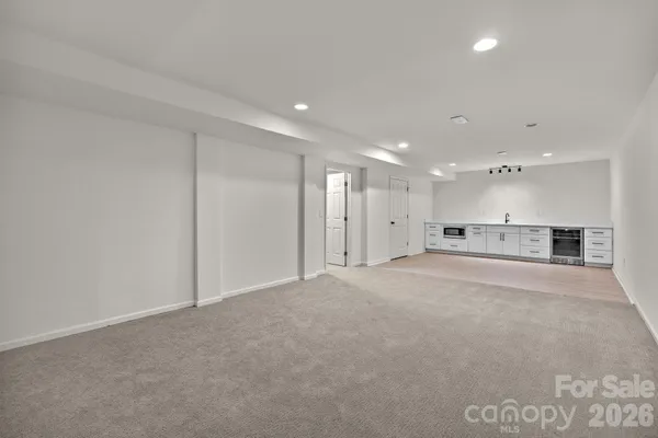 a kitchen with cabinets appliances and a sink