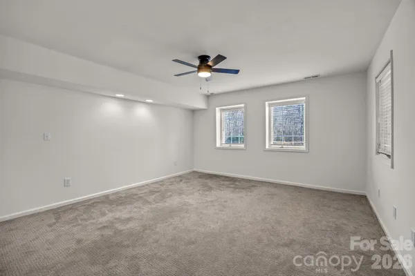 a view of an empty room with a ceiling fan