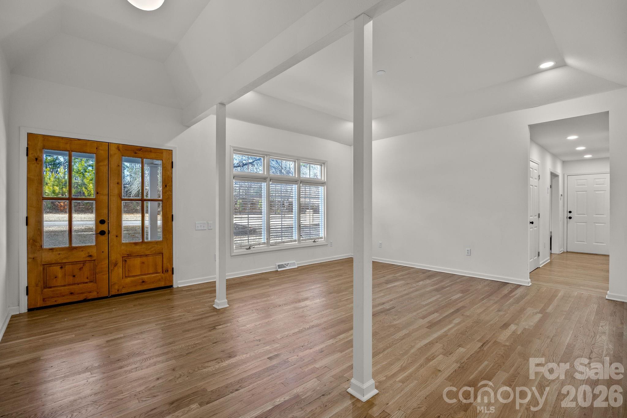 1 Sweetbriar Court Greer, SC 29650 - Photo 5 of 48 an empty room with wooden floor and windows